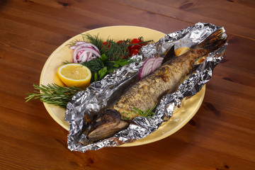Stuffed baked pike with lemon