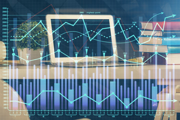 Double exposure of chart and financial info and work space with computer background. Concept of international online trading.