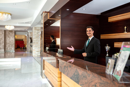 Receptionist welcoming guests to a hotel