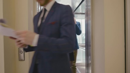 Office workers coming out of elevator