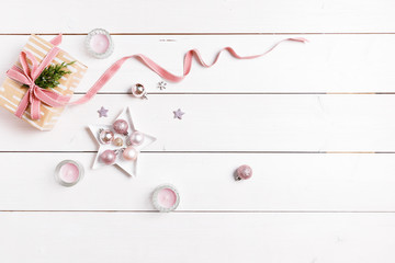 Preparation christmas gifts on a white wooden table with pink decorations