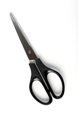 The closed scissors on a white background isolated