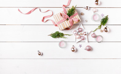Preparation christmas gifts on a white wooden table with pink decorations