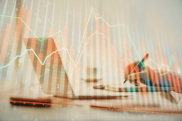 Double exposure of forex chart with man working on computer on background. Concept of market analysis.