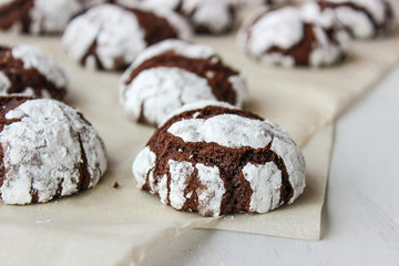 Cracked chocolate chip cookies in powdered sugar.