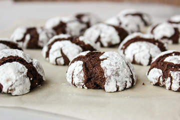 Cracked chocolate chip cookies in powdered sugar.