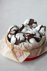 Cracked chocolate chip cookies in powdered sugar.