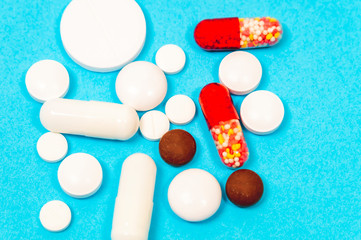 pills and thermometer on a blue background, the concept of a flu epidemic