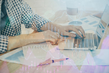 Multi exposure of stock market chart with man working on computer on background. Concept of financial analysis.