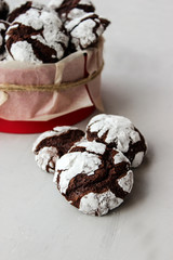 Cracked chocolate chip cookies in powdered sugar.