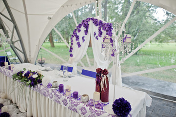 Beautiful wedding set decoration in the restaurant. Table of newlyweds outdoor tent.