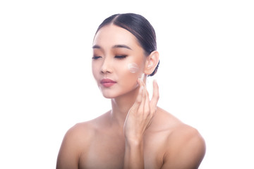 Beautiful Young Asian Woman with Clean Fresh Skin isolate on white background. Spa, Face care, Facial treatment, Beauty and Cosmetics concept. Cream on face, touching. eye close.