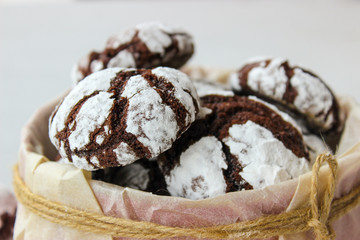 Cracked chocolate chip cookies in powdered sugar.