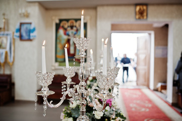 Beautiful wedding set decoration in the church ceremony. Candles.