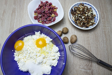 Cooking Cupcakes. In a bowl of eggs, flour. On a wooden background.