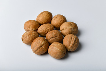walnuts on a white background. Close up view of walnuts. Walnuts are 4 water, 15 protein, 65 fat and 14 carbohydrates, including 7 dietary fiber. In a reference portion of 100 grams.