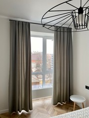 interior of a bedroacom. Curtains and window