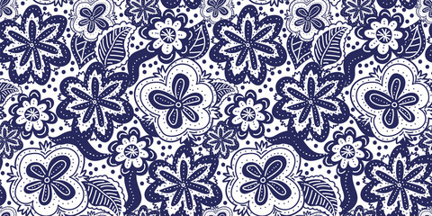 A seamless vector pattern with florals in dark blue and white. Decorative surface print design. Great for fabrics, stationery, and home decor.
