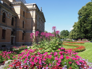 Colorful flowers in the garden next to national theatre in european capital city of Oslo at...