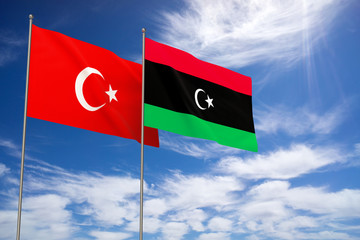Turkey and Libya flags over blue sky background.