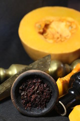 bowl with tobacco for hookah. fruits on a dark background. smoking nargile