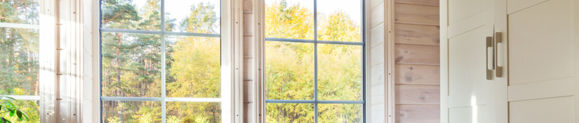 Bright interior, room in wooden house with large window. Banner. Scandinavian style.