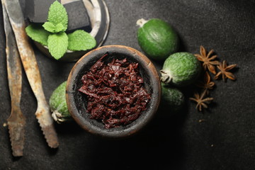 bowl with tobacco for hookah. fruits on a dark background. smoking shiisha