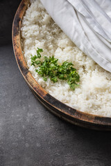 Cooked rice in a typical Japanese wooden vessel hangiri. Pile of rice before ready to prepare sushi