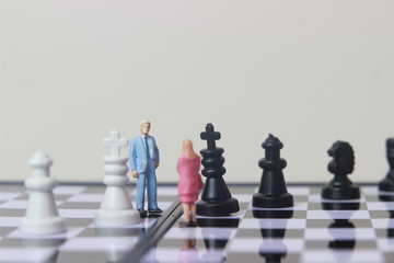 Simple illustration for photo War, Battle or politic situation concept, 2 standing mini figure, man and woman negoitation or debate beyond Small Magnetic Plastic chess