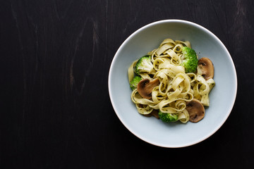 Mushroom broccoli Spaghetti Pasta and herb sauce on rustic table.  Italian traditional pasta  in bowl