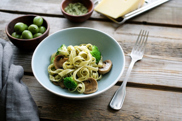 Mushroom broccoli Spaghetti Pasta and herb sauce on rustic table.  Italian traditional pasta  in bowl