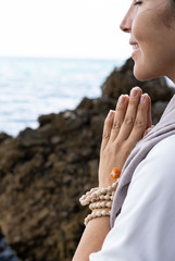 Beautiful young woman is meditating in the nature
