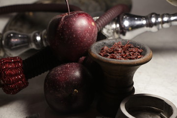 bowl with tobacco for hookah. fruits on a dark background. smoking nargile