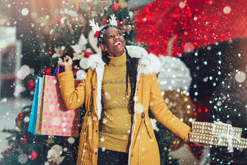 African girl shopping gifts in mall on christmas sale. New year holidays concept.