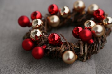 New Year 's wreath of branches and gold and red balls on beige background