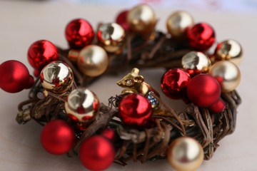 Gold and red balls in a wreath of branches for the new year and Christmas