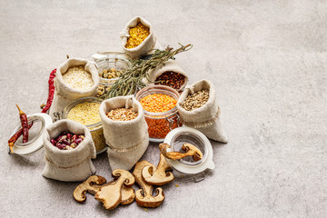 Zero waste food shopping concept. Cereals, pasta, legumes, dried mushrooms, spices. Sustainable lifestyle, old wooden boards background