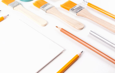 Art mockup with brushes, pencils in orange color scheme. Designer or artist workplace. Trendy template.