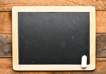 Empty chalk board on a wooden board. Top view, high resolution photography - business concept.