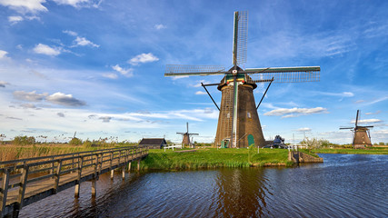 Wooden bridge goes to the dutch windmill in Kinderdijk