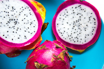 dragon fruit sliced rings on a blue plate, tropical fruit