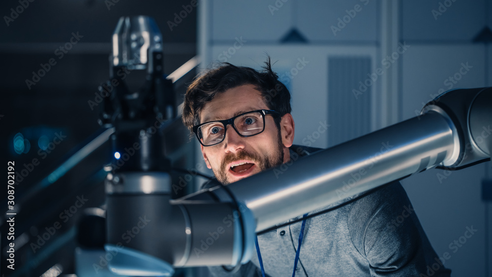 Leinwandbilder shot of a mechanical engineer works with futuristic robotic arm. robot is moving metal object. high 