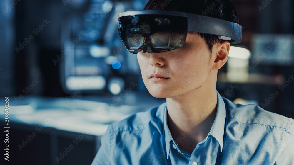 Poster professional japanese electronics development engineer in blue shirt is wearing a virtual reality he