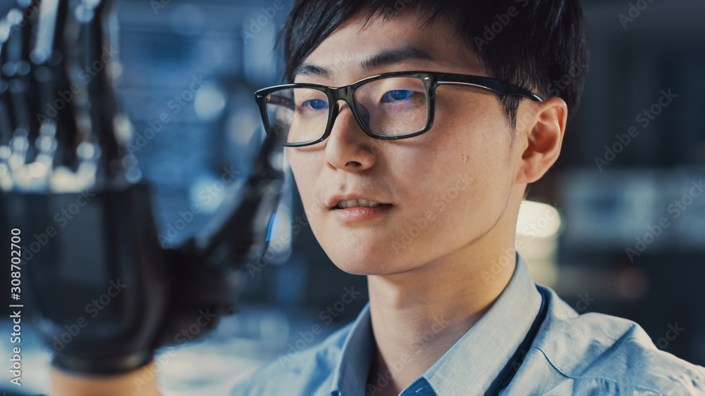 Poster Close Up of a Futuristic Prosthetic Robot Arm Being Tested by a Professional Japanese Development Engineer in a High Tech Research Laboratory with Modern Computer Equipment.