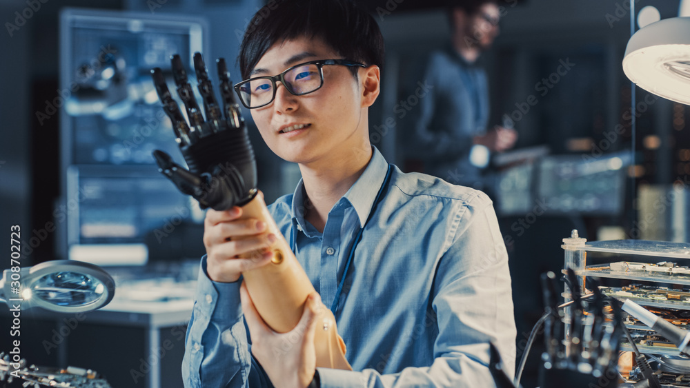 Aufkleber futuristic prosthetic robot arm being tested by a professional japanese development engineer in a hi