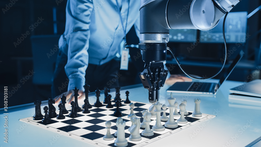 Poster Close Up Shot of a Artificial Intelligence Operating a Futuristic Robotic Arm in a Game of Chess Against a Human. Robot Moves a Pawn. They are in a High Tech Modern Research Laboratory.