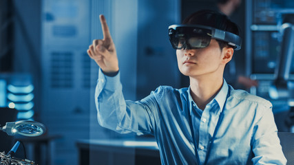 Professional Japanese Development Engineer is Working in a AR Headset, Moving Virtual Pieces Around...