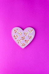 Candy hearts made of white chocolate and sublimated strawberries on a pink background. Valentine's Day.