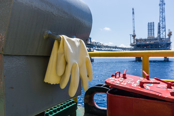 Rubber glove of a catering worker on board a construction work barge at oil field