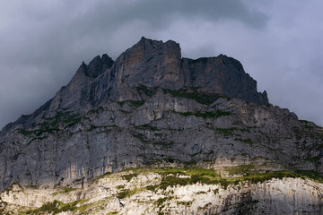 Dark rocky mountain. Switzerland. High Alps mountains. Severe alpine landscape.